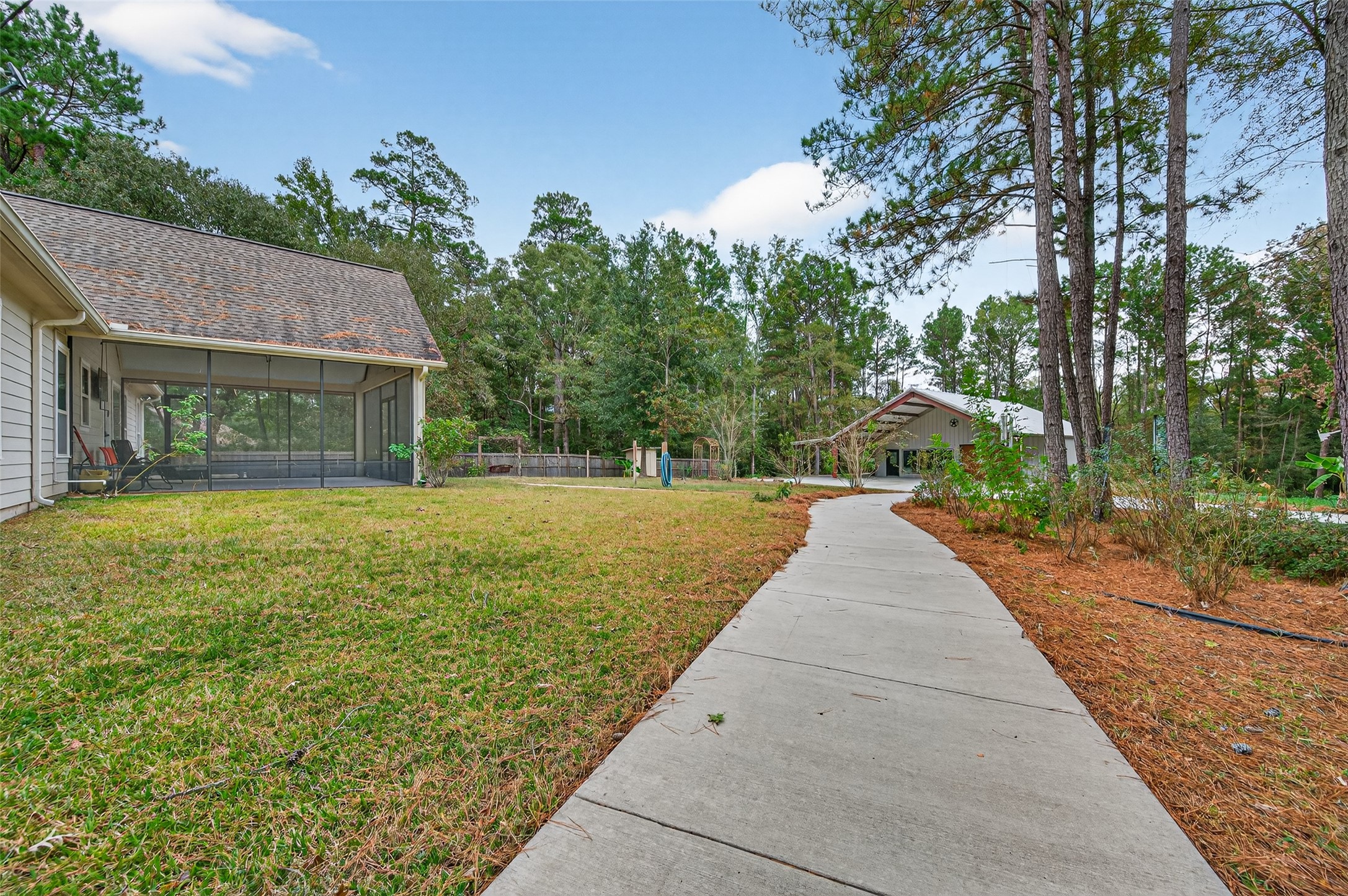 12322 High Fire Road Montgomery, TX 77356 - Photo 43 of 45 Walking path to the shop from the first driveway and additional path out of the screened in porch.