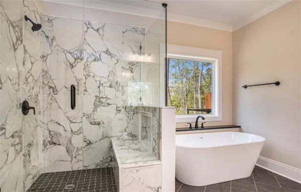 a bathroom with a bathtub and shower