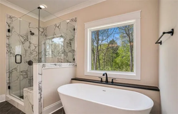 a white bath tub sitting next to a white sink