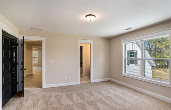 an empty room with windows and closet