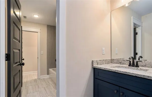 an empty room with closet and mirror