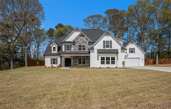 a front view of a house with a garden