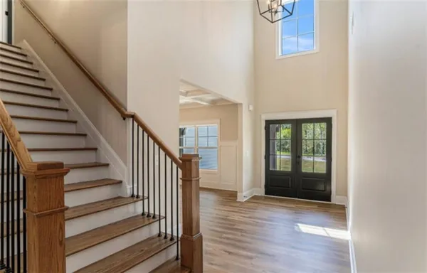 a view of entryway with wooden floor and stairs