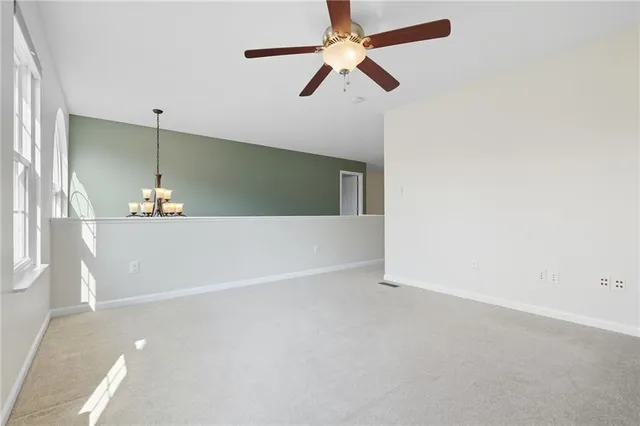 a view of a room with window and a ceiling fan