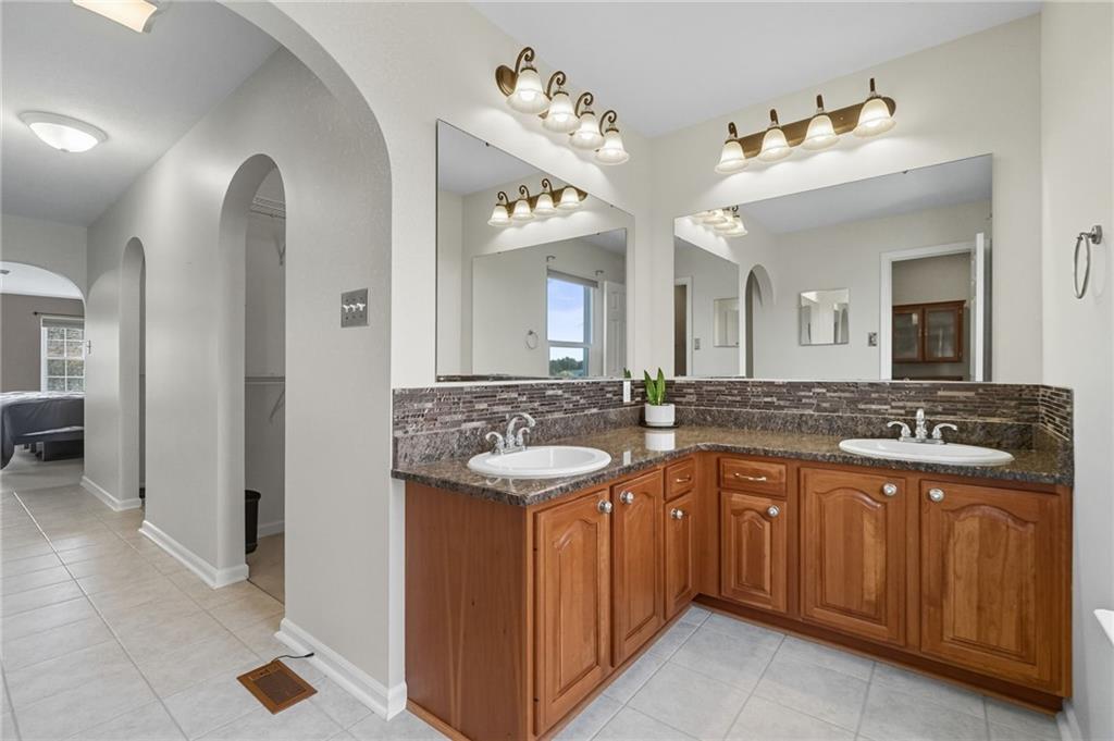 499 West Spring Grove Boulevard Rostraver Township, PA 15012 - Photo 23 of 46 a spacious bathroom with a granite countertop sink and a mirror