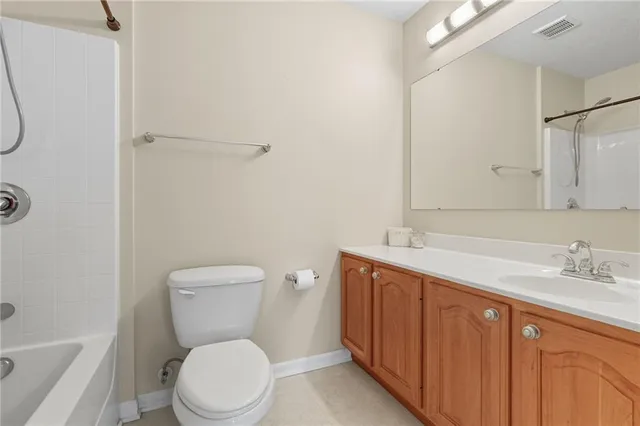 a bathroom with a toilet a sink a vanity and mirror