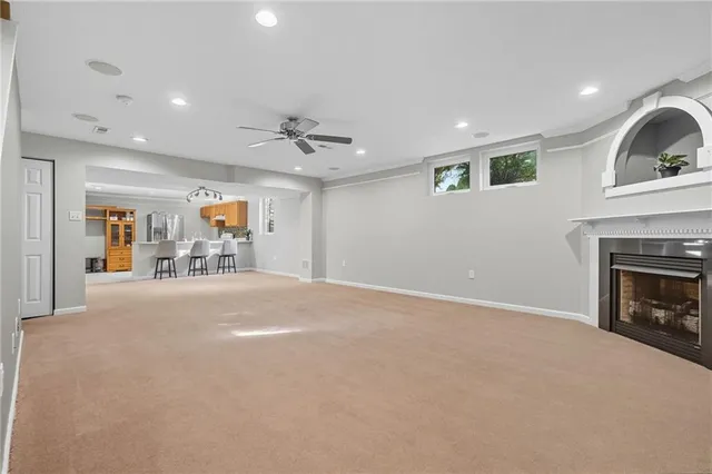 a kitchen with stainless steel appliances kitchen island granite countertop a table and chairs in it