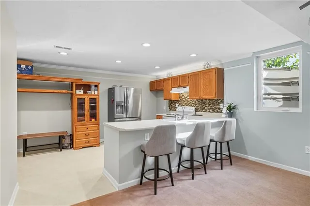 a kitchen with stainless steel appliances a refrigerator sink and cabinets