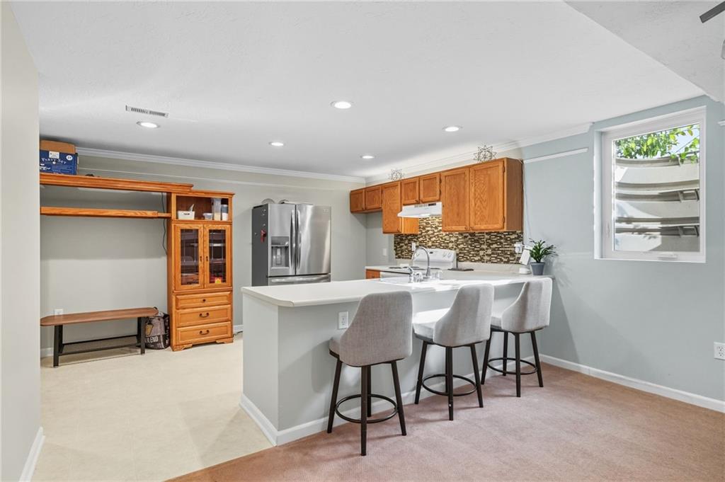 499 West Spring Grove Boulevard Rostraver Township, PA 15012 - Photo 34 of 46 a kitchen with stainless steel appliances kitchen island granite countertop a table and chairs in it