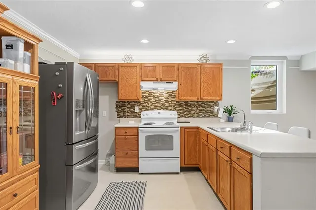 a view of a sink and dishwasher with wooden floor