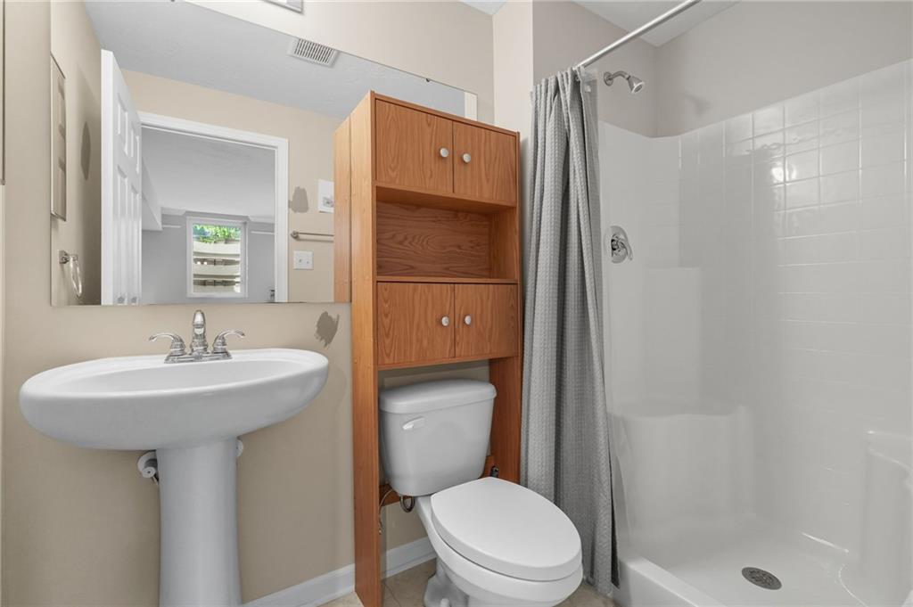 499 West Spring Grove Boulevard Rostraver Township, PA 15012 - Photo 38 of 46 a bathroom with a sink toilet and shower