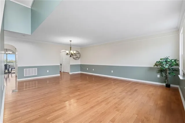 a view of an empty room with a chandelier