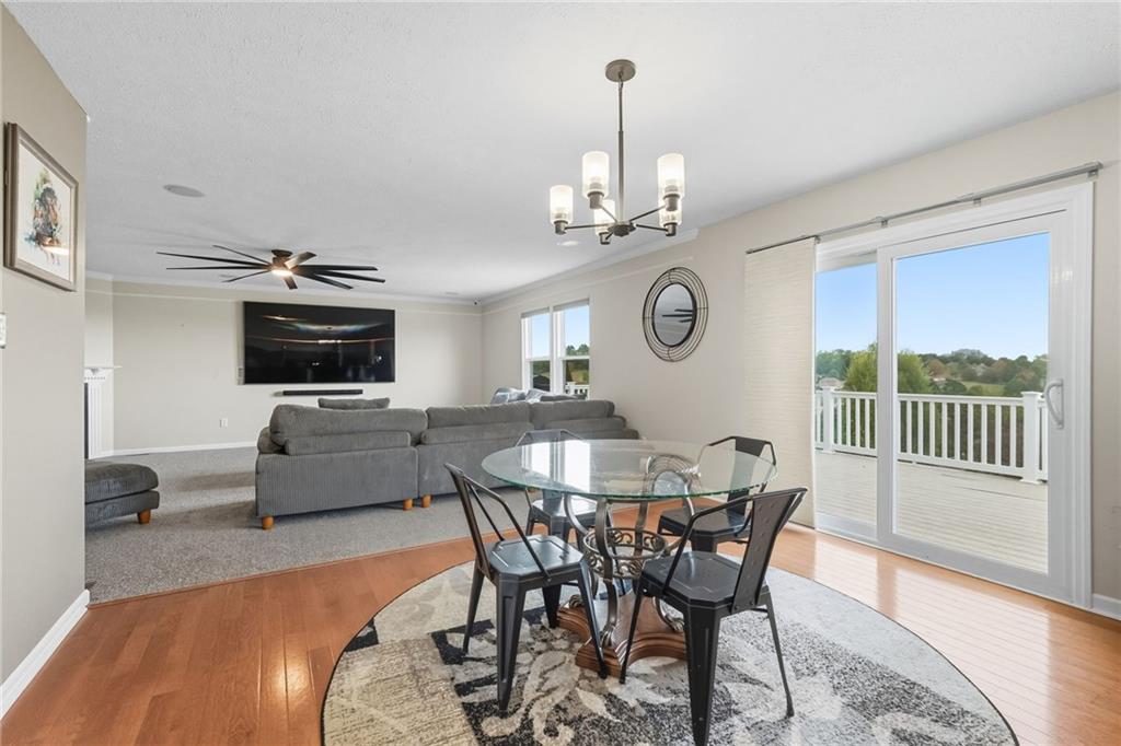 499 West Spring Grove Boulevard Rostraver Township, PA 15012 - Photo 10 of 46 a view of a dining room with furniture a chandelier and wooden floor
