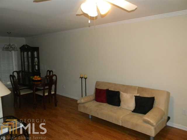 112 Summer Place Northwest Norcross, GA 30071 - Photo 1 of 1 a living room with furniture and wooden floor