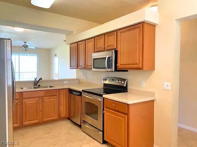 a kitchen with stainless steel appliances granite countertop a sink stove and microwave