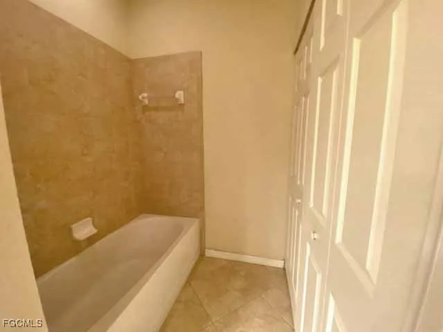 a bathroom with a tub and shower