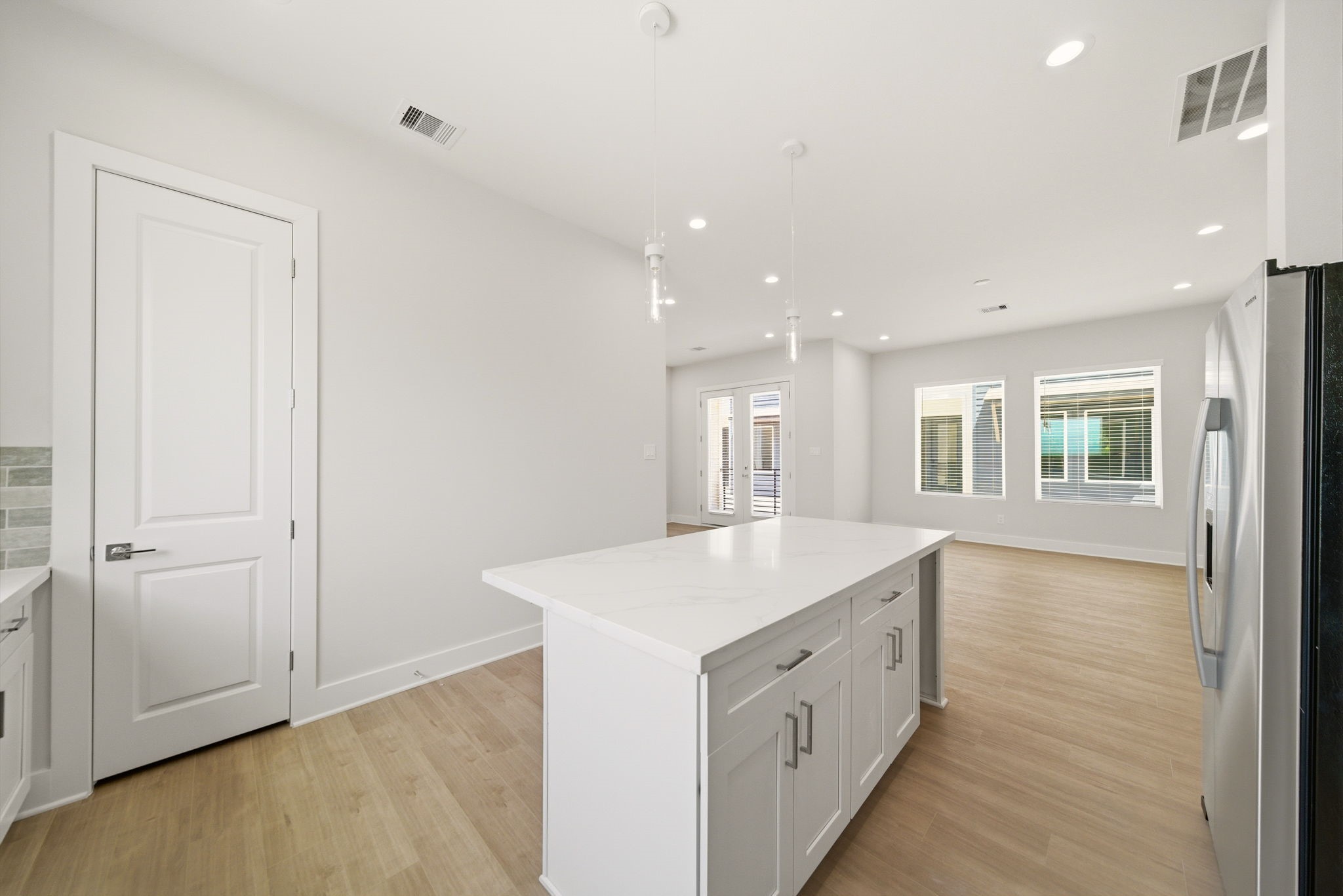 1398 Cedar Post Lane Houston, TX 77080 - Photo 12 of 33 a large white kitchen with a sink and dishwasher with wooden floor