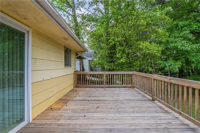 a balcony with view of trees in the background