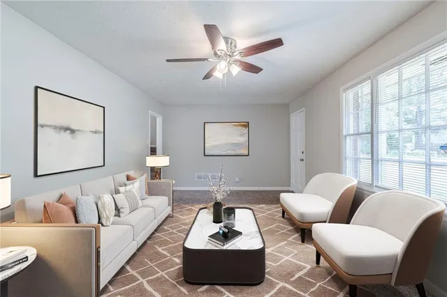 a living room with furniture and a large window