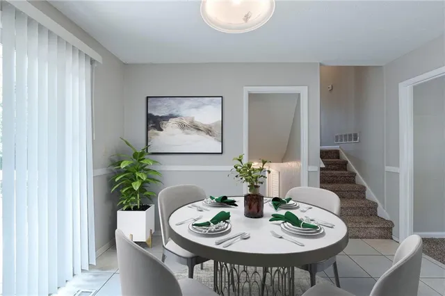 a dining room with furniture potted plants and wooden floor