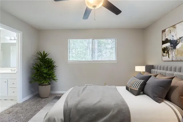 a bedroom with a bed and a potted plant