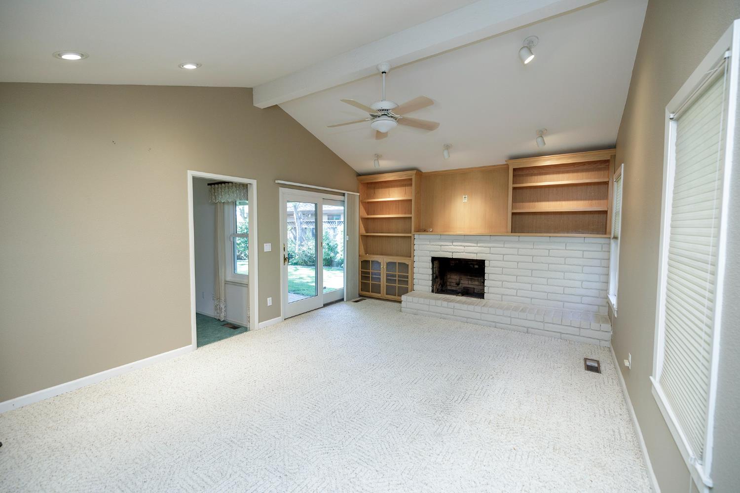 1001 Winsted Lane Modesto, CA 95355 - Photo 12 of 45 a view of an empty room with a fireplace and a window