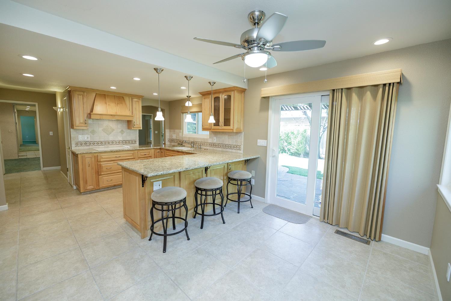 1001 Winsted Lane Modesto, CA 95355 - Photo 21 of 45 a large kitchen with a table and chairs
