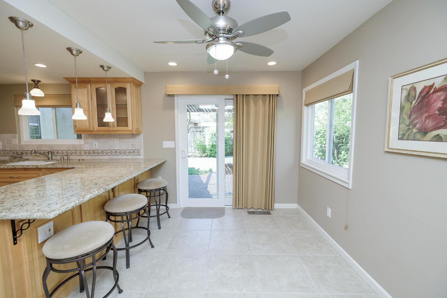 1001 Winsted Lane Modesto, CA 95355 - Photo 22 of 45 a bathroom with a granite countertop sink a mirror and a bathtub