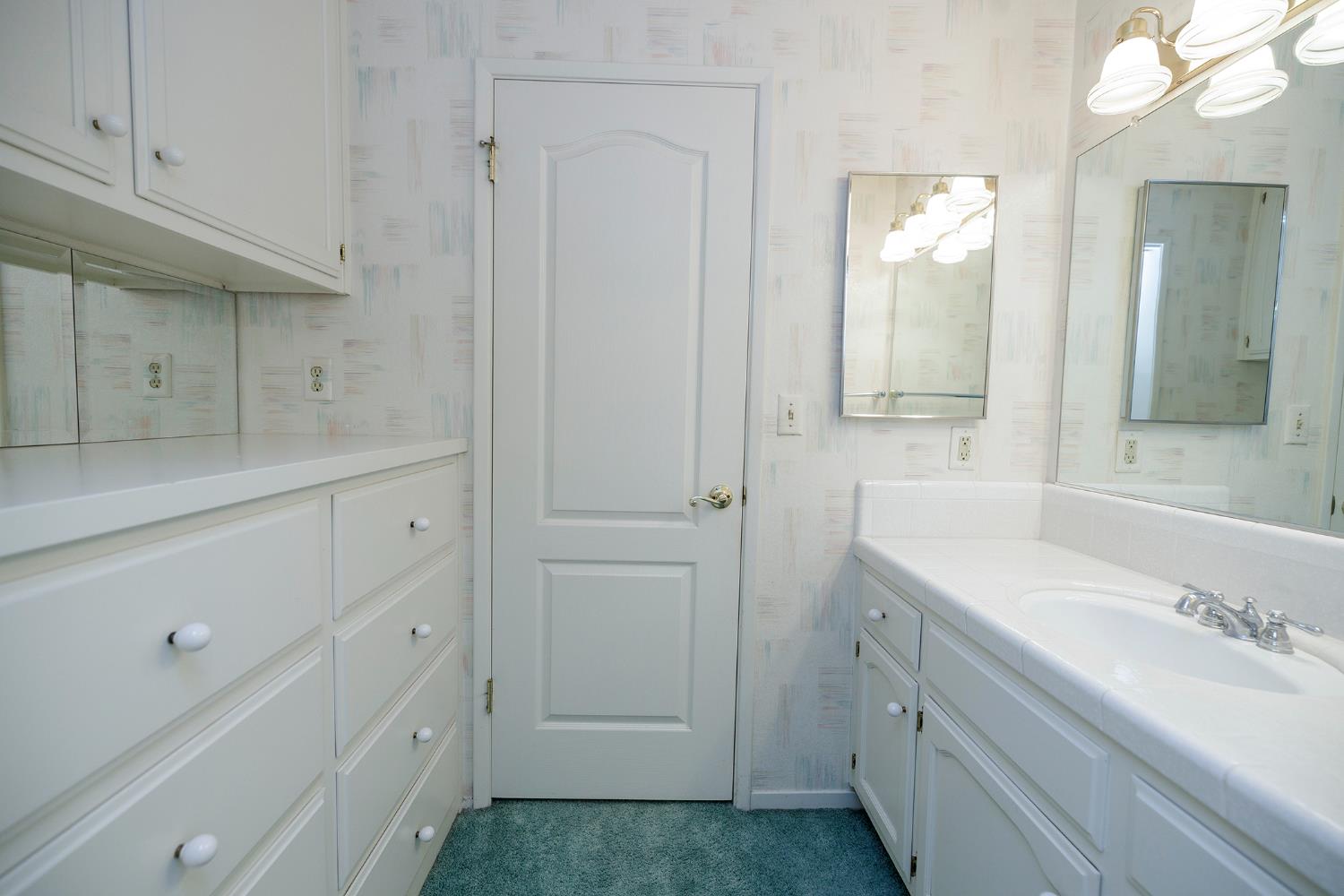 1001 Winsted Lane Modesto, CA 95355 - Photo 28 of 45 a bathroom with a sink and a mirror