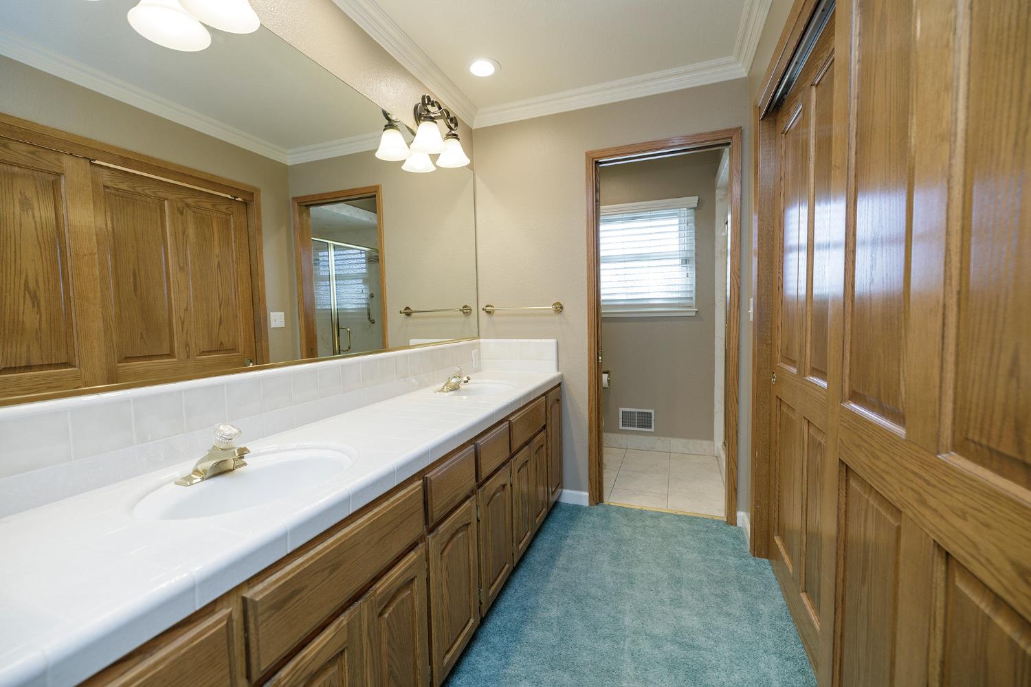1001 Winsted Lane Modesto, CA 95355 - Photo 31 of 45 a spacious bathroom with a double vanity sink and a mirror