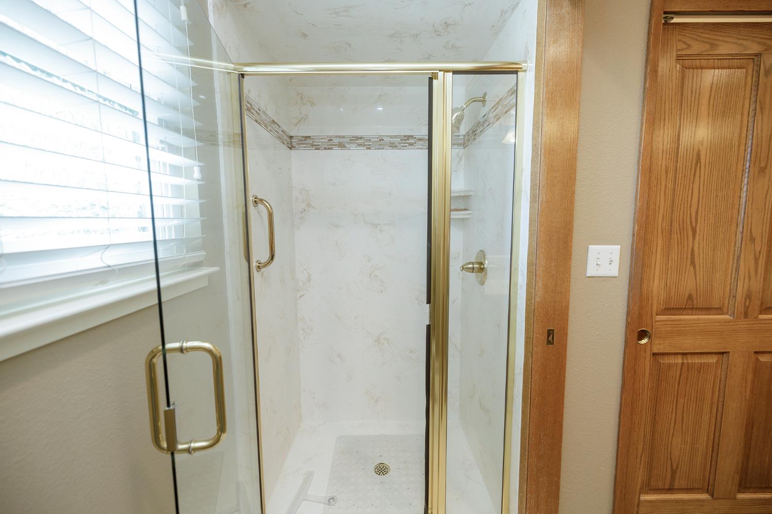 1001 Winsted Lane Modesto, CA 95355 - Photo 32 of 45 a bathroom with a glass shower door