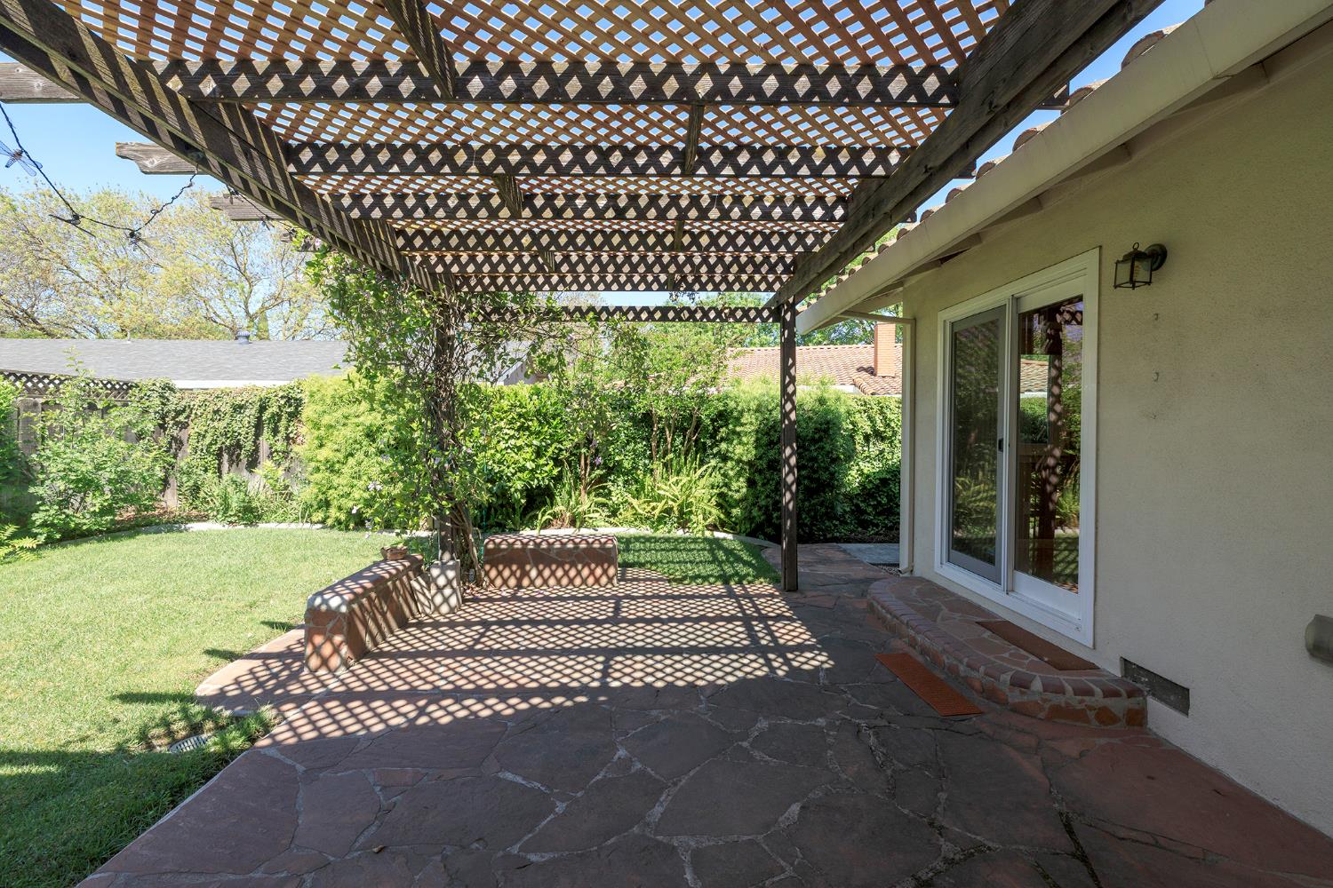 1001 Winsted Lane Modesto, CA 95355 - Photo 37 of 45 a porch with a bench next to a yard