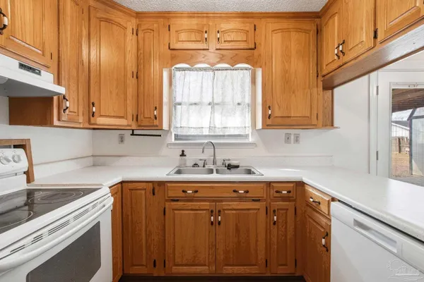 a kitchen with a sink a cabinets and window