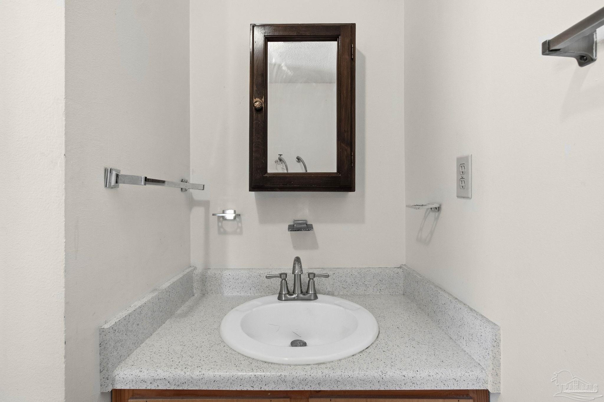 104 Thorndale Place Atmore, AL 36502 - Photo 21 of 39 a bathroom with a sink and a mirror