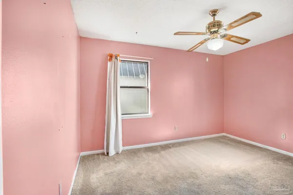 an empty room with a fan and a fan