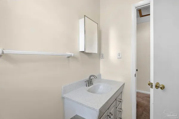 a view of a house with a large window and wooden fence