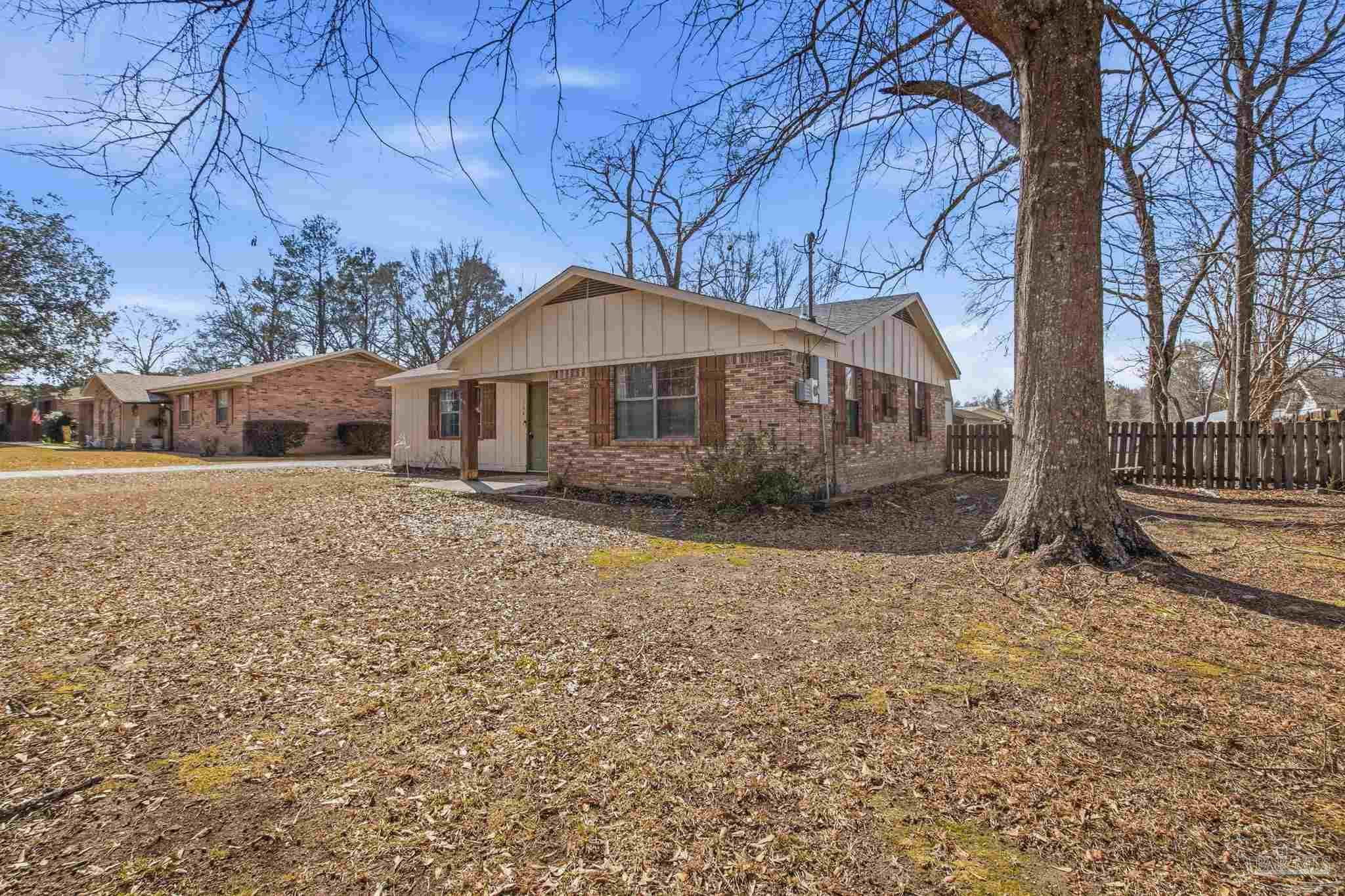 104 Thorndale Place Atmore, AL 36502 - Photo 3 of 39 a front view of a house with a yard