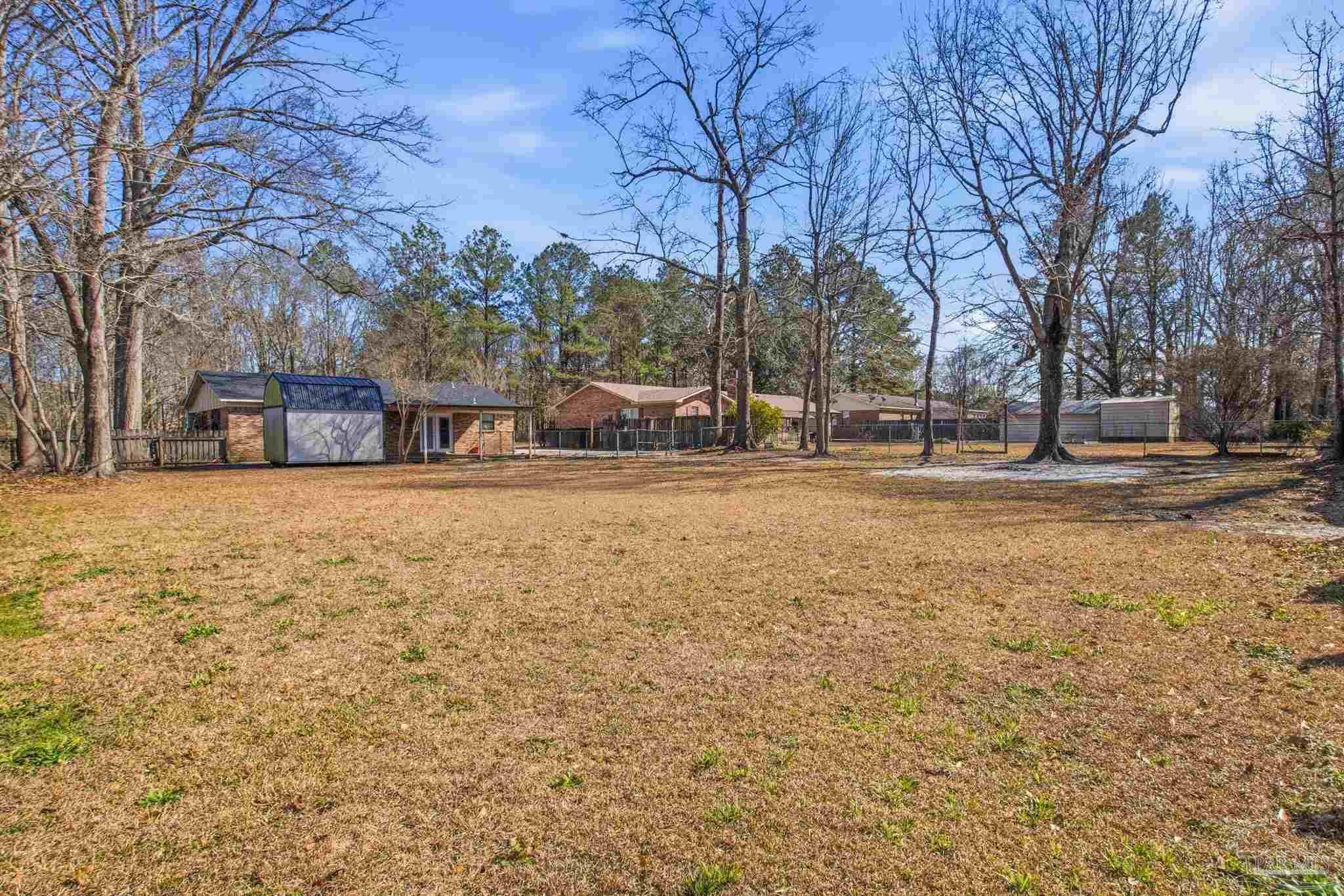 104 Thorndale Place Atmore, AL 36502 - Photo 36 of 39 a view of a yard with a house and a large tree