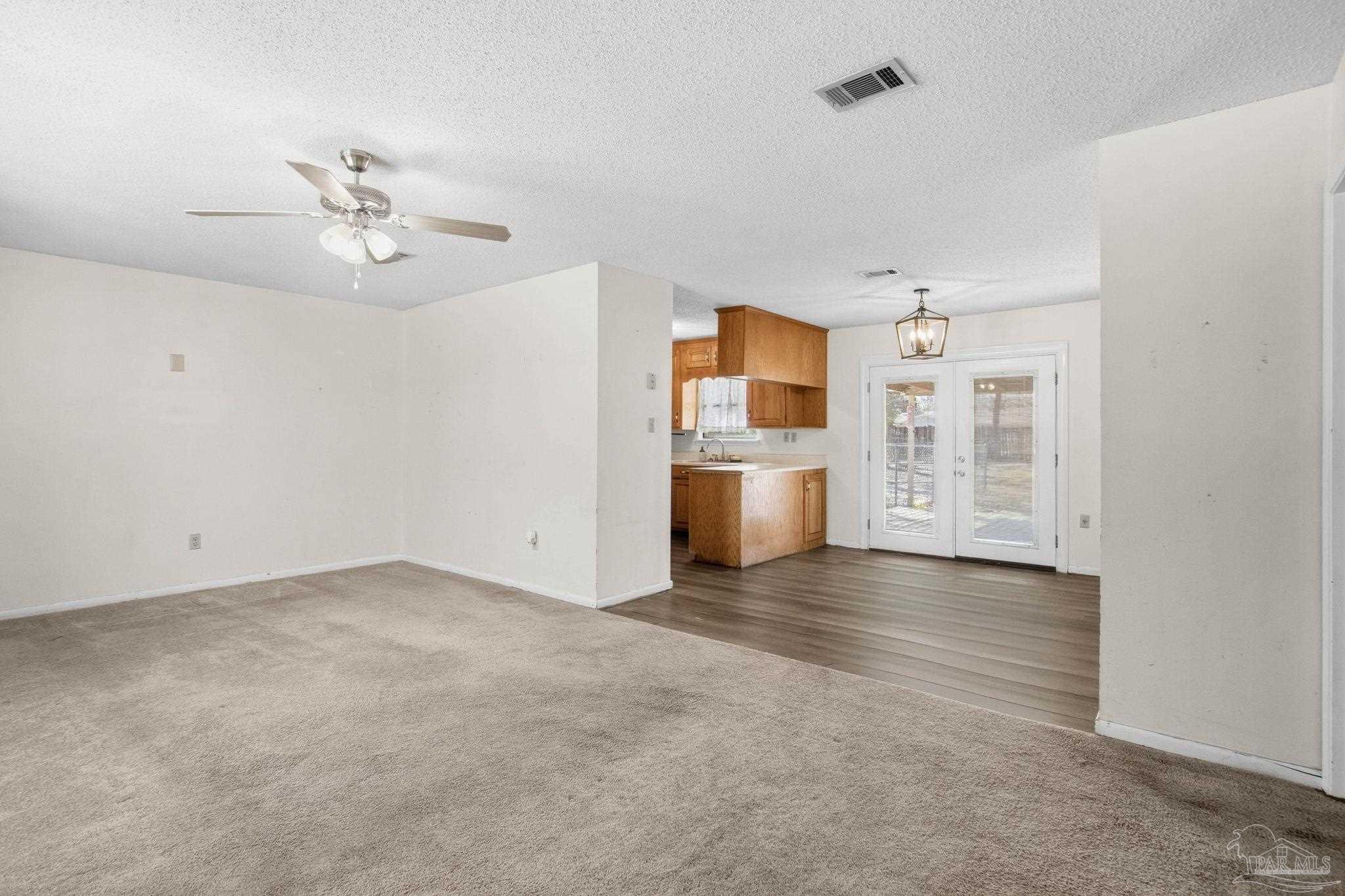 104 Thorndale Place Atmore, AL 36502 - Photo 4 of 39 a view of a kitchen with a stove cabinets a ceiling fan and wooden floor