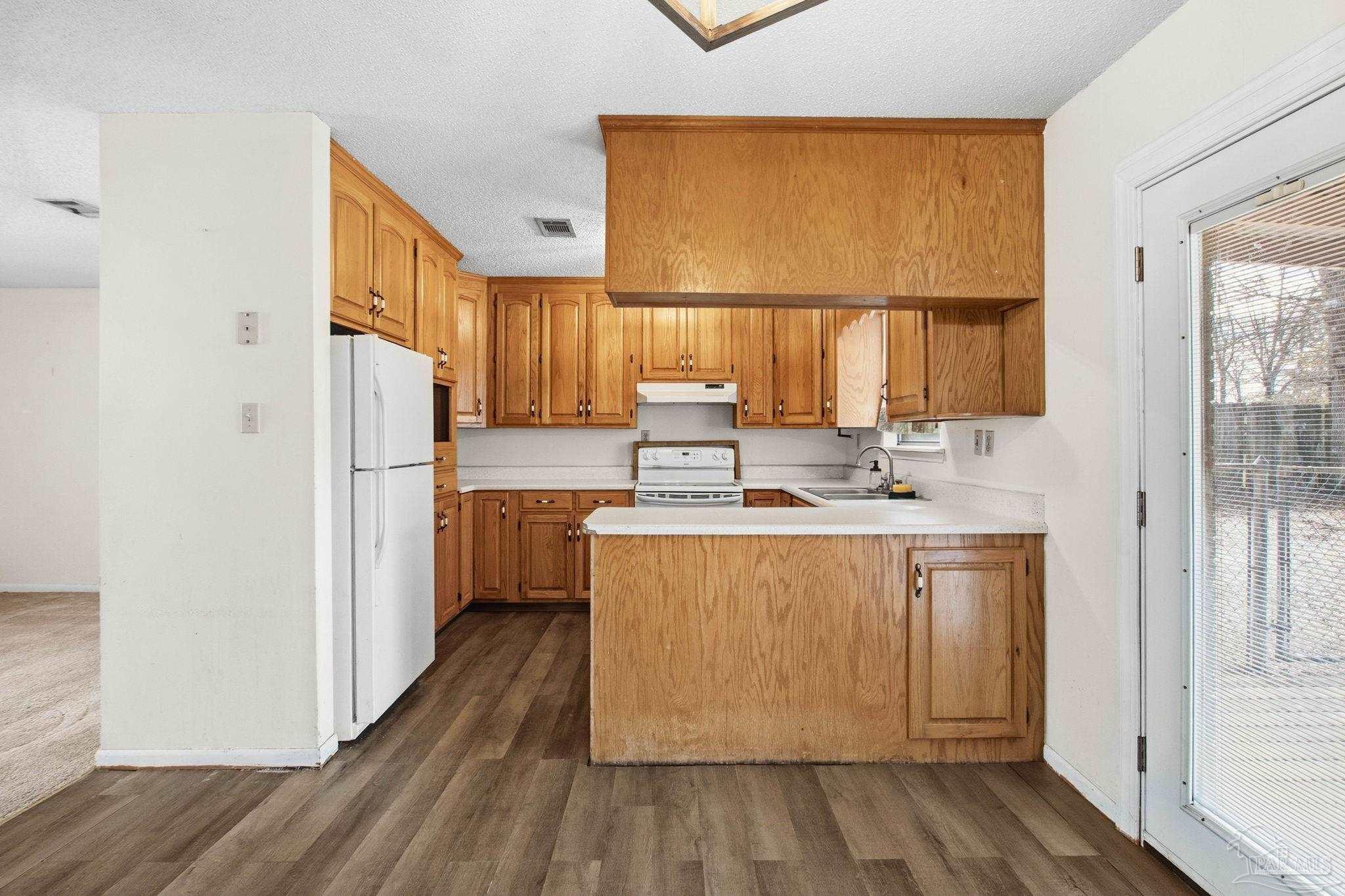 104 Thorndale Place Atmore, AL 36502 - Photo 10 of 39 a kitchen with a sink cabinets stainless steel appliances and a window