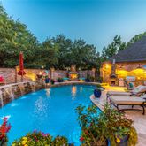 an outdoor space with swimming pool and furniture