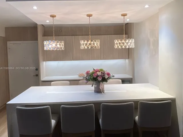 a view of a dining room with furniture and chandelier