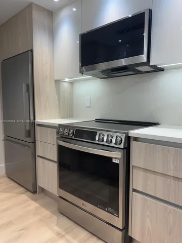 a stove top oven sitting inside of a kitchen