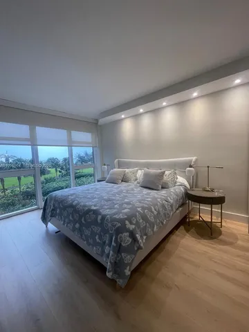 a spacious bedroom with a bed and large window