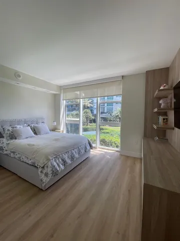 a bedroom with a large bed and a large window