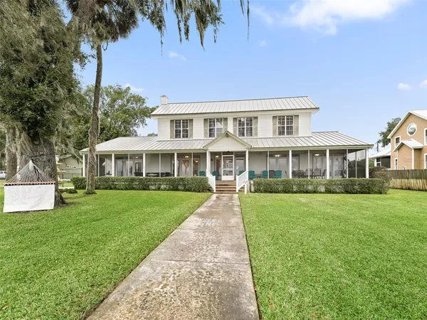 a large kitchen with stainless steel appliances granite countertop a refrigerator and a sink