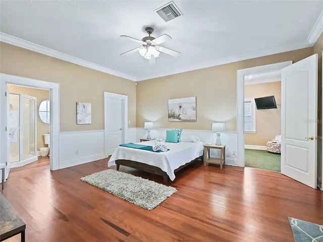 a large white kitchen with granite countertop a large window a sink and white stainless steel appliances