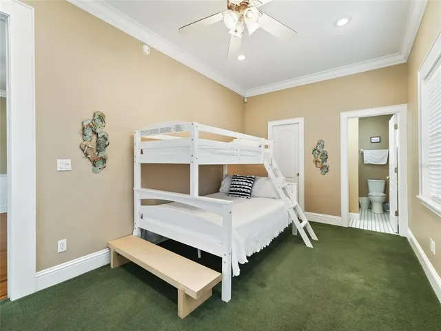 a spacious bedroom with a bed a couch and a large window