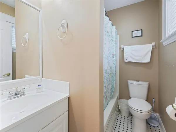a spacious bathroom with a granite countertop sink and a mirror