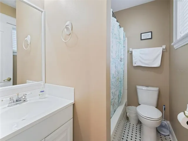 a spacious bathroom with a granite countertop sink and a mirror